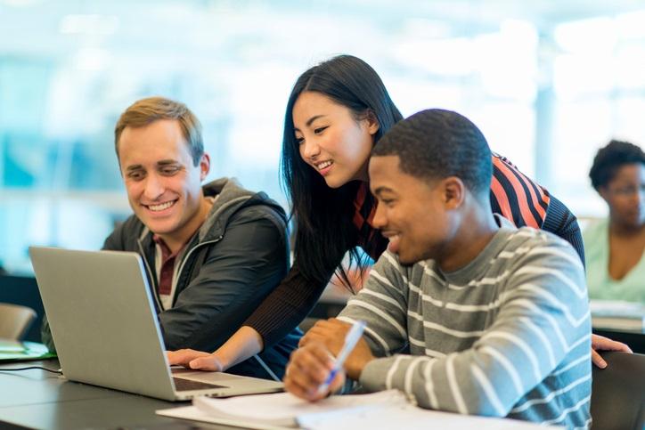 Students in classroom around computer